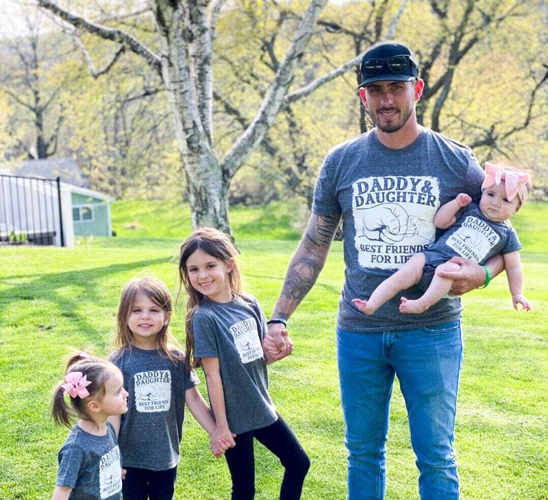 dad and daughters wearing matching shirts