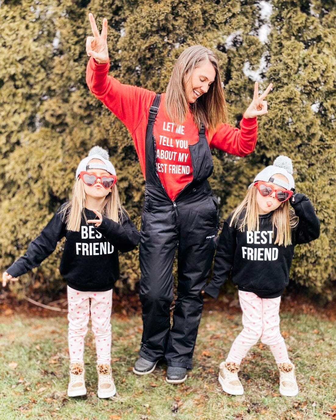 Mom and two daughters wearing set of matching best friends shirts
