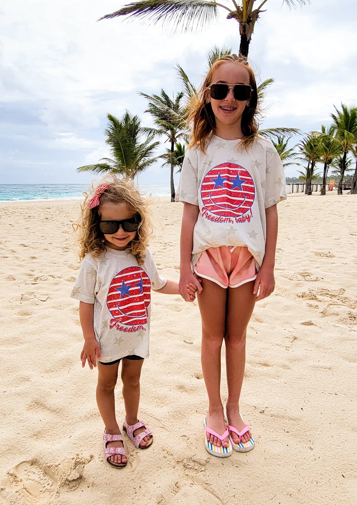 Two kids wearing matching 4th of July shirts